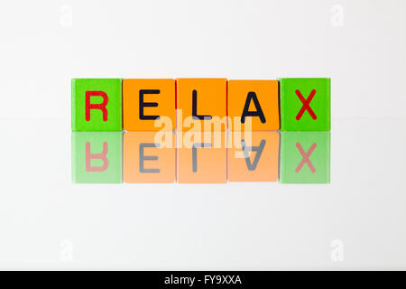 Relax - an inscription from children's wooden blocks Stock Photo