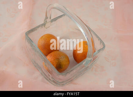 Blood red oranges in glass basket on tablecloth Stock Photo