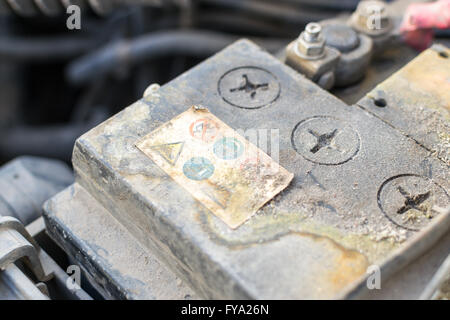 Closeup image of a corroded and defective car battery showing erosion of the terminals and residue build up Stock Photo