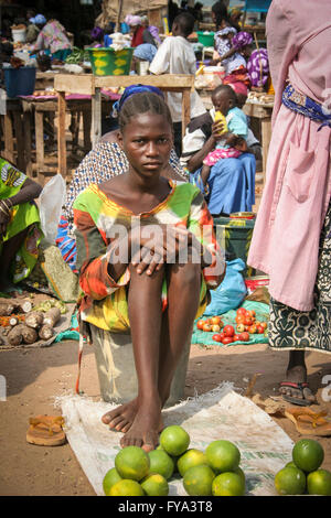 African young woman selling lemons at Tanjih fish market, the biggest African fish market, Gambia, Africa Stock Photo