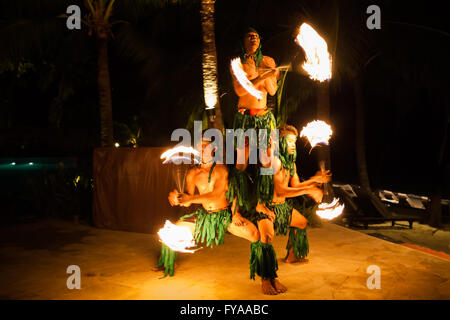 Koh Samui, Thailand - August 24, 2013: Three strong men performing traditional fire dance at tropical resort on Koh Samui Island Stock Photo