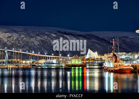 night shot of snow covered landscape of harbour and Arctic Cathedral in Tromsø, Troms, Norway, Europe Stock Photo