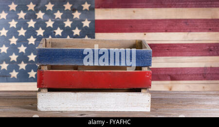 Wooden crate with vintage wooden USA flag in background. Stock Photo