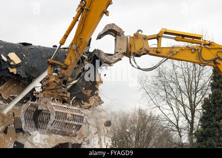 Demolition cranes dismantling a building