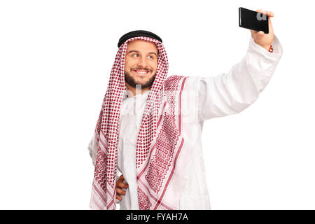 Modern Arab taking a selfie with cell phone and smiling isolated on white background Stock Photo