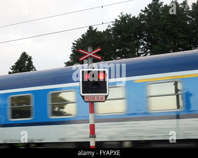 Czech Republic - Horni Vilimec. Passenger train passes gateless railroad crossing. Stock Photo