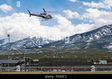 'Reach' Flight for Life medical helicopter landing on high school field Stock Photo