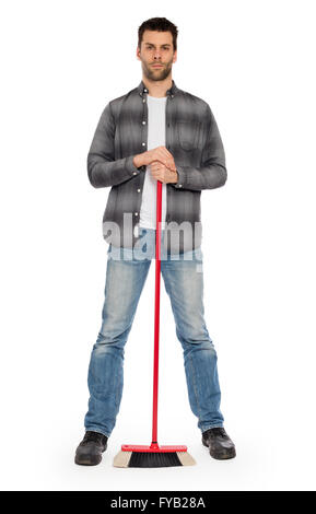 Full isolated studio picture from a young worker with a broom Stock Photo