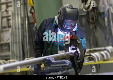 Industrial worker setting orbital welding machine. Stock Photo