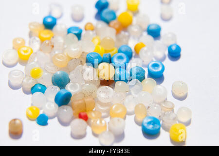A collection of small plastic nurdles photographed on a white background. Stock Photo
