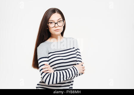 Beautiful woman in glasses and arms folded standing isolated on a white background Stock Photo