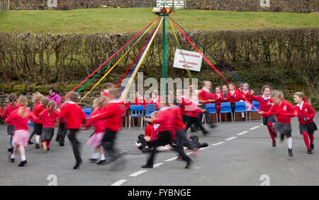 Wray, Lancashire, UK 25th April, 2016.  Maypole Dancing at Wray's Annual Scarecrow Festival.  The villagers are back again having created some weird, wacky and wonderful scarecrow creations to delight visitors. Annually Wray village hosts a display of scarecrows to fit in with a subject on the school curriculum, with creations popping up on village gardens, peeking out of windows and perching on balconies. The Scarecrow Festival, established 1995, takes place during the week leading up to May Day when there is a fair and a weekend parade of the giants. Credit:  Mar Photographics/Alamy Live New Stock Photo