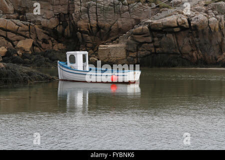 Small white fishing boat Ireland at The Rosses near Burtonport County Donegal, Ireland. The boat is either on Inishcoo, or Eighter Island. Stock Photo