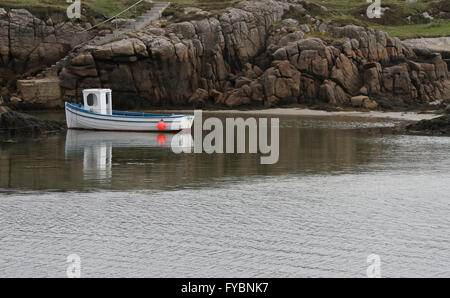 Small white fishing boat Ireland at The Rosses near Burtonport County Donegal, Ireland. The boat is either on Inishcoo, or Eighter Island. Stock Photo