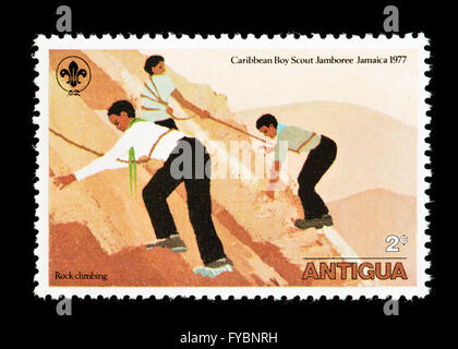 Postage stamp from Antigua depicting Boy Scouts rock climbing, issued for the 1977 Caribbean Jamboree in Jamaica Stock Photo