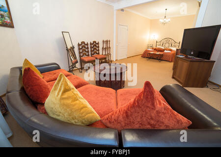 apartment interior in turkish style with sofa, pillows and wooden art carved small table Stock Photo