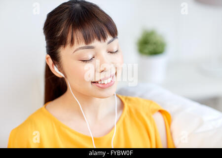 happy asian woman with earphones listening music Stock Photo