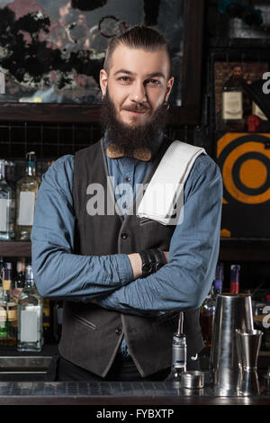 Happy barman at work with crossed hands. Stock Photo