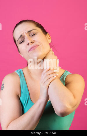 Woman hands on neck in pain Stock Photo