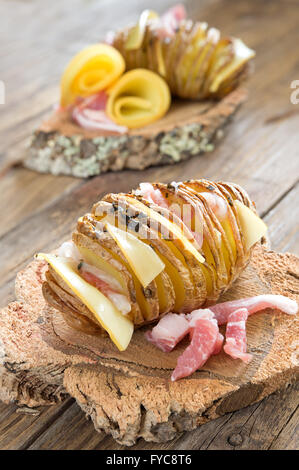 jacket potato with bacon and sliced provola cheese Stock Photo