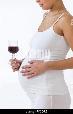 PREGNANT WOMAN DRINKING Stock Photo