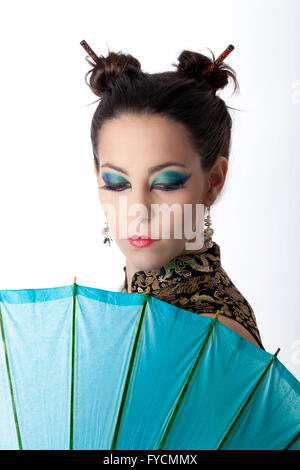 Model wearing a Chinese dress with umbrella in the studio. Edinburgh Stock Photo