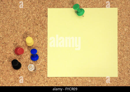 Post it and colorful thumbtacks on cork board Stock Photo