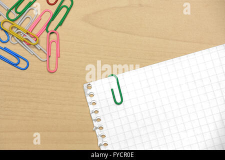 Colorful paper clips on wood with grid papers Stock Photo