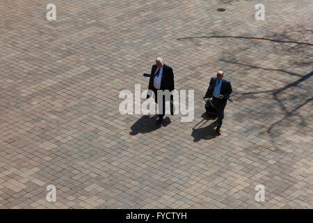 Elderly businessmen walking toward building - USA Stock Photo