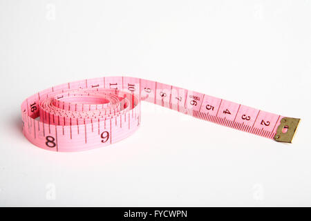 Pink tape measure roll isolated on the white background Stock Photo - Alamy