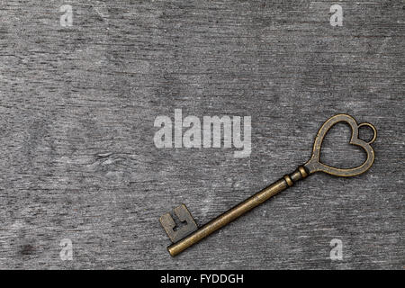 golden heart shaped vintage key on grunge wooden background Stock Photo ...