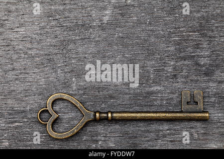 golden heart shaped vintage key on grunge wooden background Stock Photo ...