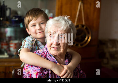 Portrait of an elderly woman with a small grandson in the background. Stock Photo
