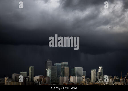 London, UK. 25th April, 2016. UK Weather: dark rainy cloudy skies over Canary Wharf business park buildings Credit:  Guy Corbishley/Alamy Live News Stock Photo