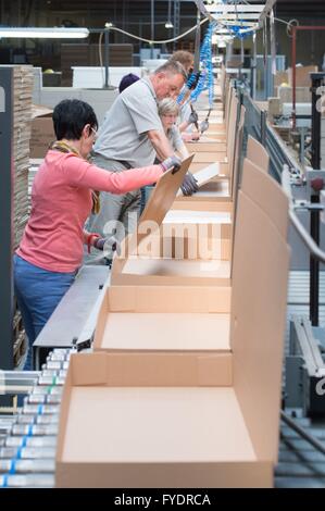 Production workers pack wooden components of the Maja Moebelwerk in Wittichenau (Saxony), Germany, 20 April 2016. The furniture manufacturing company 'Maja' makes lightweight furnitures for Ikea. Photo: Sebastian Kahnert/dpa Stock Photo