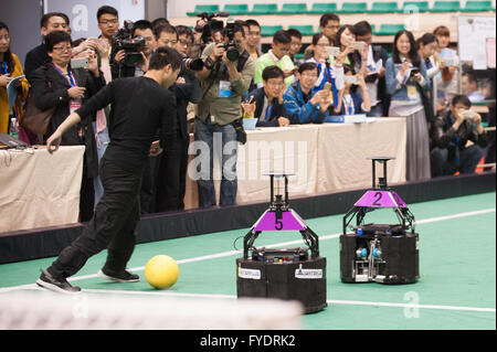 Hefei, China's Anhui Province. 26th Apr, 2016. Chinese robot-football team 'Water', a former champion, compete against a human player during the 2016 RoboCup China Open in Hefei, capital of east China's Anhui Province, April 26, 2016. Nearly 2,000 participants from 300 teams across the country took part in the competitions. Credit:  Meng Dingbo/Xinhua/Alamy Live News Stock Photo