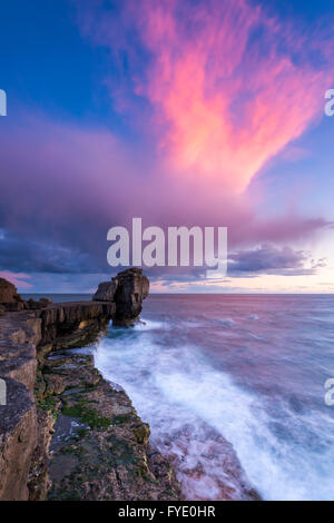 Portland Bill, Dorset, UK. 26th April 2016.  UK Weather - A storm cloud is illuminated by the setting sun above Pulpit Rock at Portland Bill on the Jurassic Coast of Dorset - Picture: Graham Hunt /Alamy Live News Stock Photo