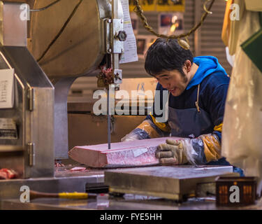 TOKYO, JAPAN - November, 22, 2014: Tuna sellers at Tsukiji, the biggest fish and seafood market in the world. Stock Photo