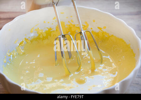 preparing a sponge cake with  the ingredients worked with a food-mixer Stock Photo