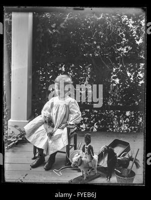 Victorian photograph of a young boy with his toys on a porch in Fallston, Maryland. Stock Photo