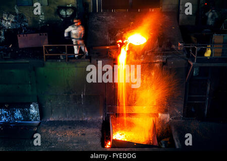 Pouring of liquid metal in open hearth workshop Stock Photo