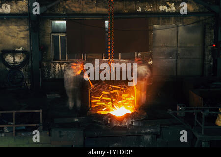 Pouring of liquid metal in open hearth workshop Stock Photo