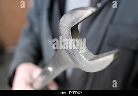 male motor mechanic holding large open ended spanner Stock Photo