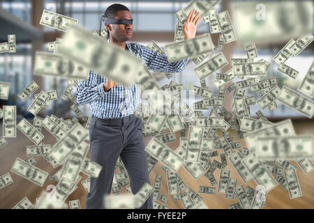 Composite image of blindfolded businessman with arms out Stock Photo