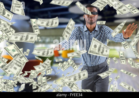 Composite image of blindfolded businessman with arms out Stock Photo