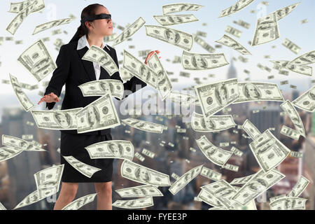 Composite image of blindfolded businesswoman with hands out Stock Photo