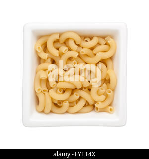Uncooked elbow macaroni in a square bowl isolated on white background Stock Photo