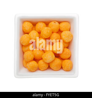Cheese flavor corn snack in a square bowl isolated on white background Stock Photo