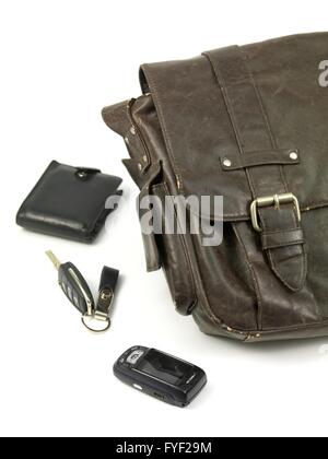 A leather bag and contents isolated against a white background Stock Photo