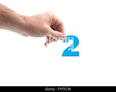 Numbers held by a hand isolated against a white background Stock Photo